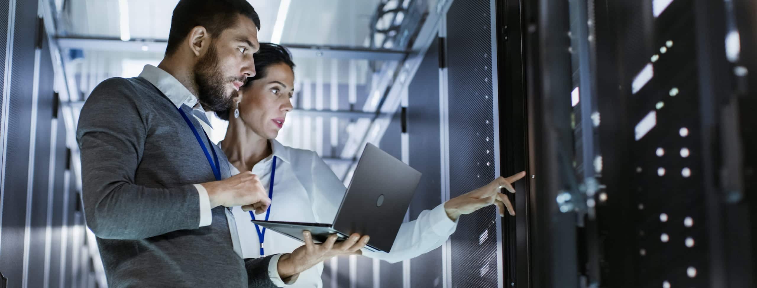 two people in a computer server room